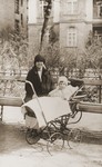 Gertrud Gotthelf poses with her daughter, Lore, who is sitting in a baby carriage.