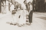 The three Stern sister-in-laws, Lizbet (left), Hedva (center) and Resi (right), walk down a street in Willebadessen.