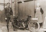 Mathilde Stern poses with her son, Viktor, next to his motorcycle.