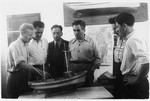 Jewish DPs examine a model of a fishing boat at the Migdalor hachshara, a maritime Zionist collective in Fano, Italy.