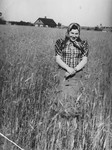 Ita Grynberg stands in a wheat field near her parents' house.