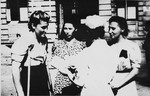 A nurse converses with three Polish female survivors of the Ravensbrueck concentration camp who had been subjected to medical experimentation during their imprisonment.