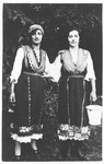 Two Jewish sisters pose in traditional Bulgarian dress.