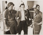 A French resistance fighter, whose hands were cut off by Germans, receives medical attention from U.S.