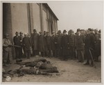 Under the supervision of American soldiers, mayors and townspeople from Gardelegen and other surrounding towns are forced to view the charred corpses of prisoners shot while trying to escape a burning barn.