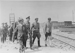Reichsfuehrer SS Heinrich Himmler tours the Monowitz-Buna building site in the company of Max Faust (wearing the fedora) and Auschwitz commandant Rudolf Hoess (second from the right in the first row).