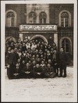 A group of Jewish DPs pose in front of a building in the Deggendorf DP camp.