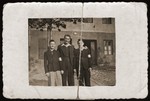 Three Jewish youth pose outside in the Dabrowa Gornicza ghetto.