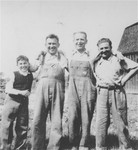 The Muller brothers, Nandor (right) and Lajos (second from the left), pose with a third Jewish refugee from central Europe who was also compelled to become a farmer in order to gain entry into Canada in the late 1930's.