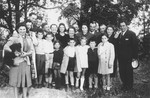 Group portrait taken on the eve of Rosh Hashana, of a number of Slovak and Hungarian-Jewish refugee families who had recently settled on farms in southern Ontario.