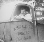 Portrait of Nandor Muller in his truck bearing the same company name as his grandfather's wholesale grain business in Czechoslovakia.