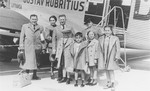 Two Jewish refugee families from Slovakia pose in front of the plane that flew them from Bratislava to Vienna, on the first leg of their journey to Canada.