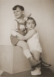 Studio portrait of two Hungarian Jewish children, Otto Friedman (age 5) and Anniko Friedman (age 13 months).