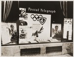 An American travel agency advertises the Summer Olympics in Berlin as well as telegrams, cablegrams, and News Flash Reports on events from the Olympic Games.