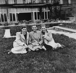 Dorottya (Dolly) Dezsoefi, left, with twin sister, Ida Marianne (Mari), right, and a friend, sit outside while in hiding at the Hotel Lukacs.