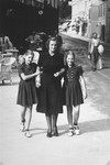 Dorottya (Dolly) Dezsoefi, (left) poses on a street with her twin sister, Ida Marianne (Mari), and their mother, Johanna Selinger.