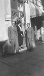 Chaya Gar stands in front of a Jewish-owned shop in Kovno with her brother Jacob and a friend, during her return visit to Lithuania in the summer of 1938.