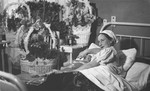 Portrait of Gita Salat Wisgardisky in a hospital in Kovno with her newborn daughter, Henia.