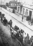 During a deportation action in the Brzeziny ghetto, Jews are taken by horse-drawn wagons to the railroad station in Galkowek.