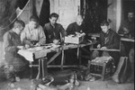 Jewish youth at work in a shoemaking workshop in the Glubokoye ghetto.