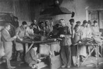 Jewish men and women make felt boots in a workshop in the Glubokoye ghetto.