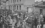 Jewish survivors in Czestochowa march along Spadkowa-Kozia Street in protest against the way Jewish victims of German actions in the small ghetto were buried in mass graves filled with lime.