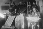 Jewish men making signs in a workshop in the Glubokoye ghetto.
