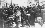 Under police supervision, Jews move their belongings into the Grodno ghetto.