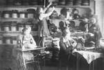 Jewish women working in a hatmaking workshop in the Glubokoye ghetto.