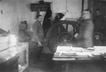 Jewish men working at a printing press in the Glubokoye ghetto.