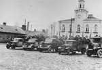 Jews are packed onto a number of trucks that are parked in front of the courthouse and city hall in Marek Square in Ciechanow.