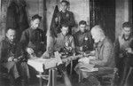 Jewish men at work in a shoemaking workshop in the Glubokoye ghetto.