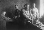 Jewish men and children at work in a metal workshop in the Glubokoye ghetto.