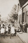 Three Jewish nurses wearing yellow stars are about to begin the 25 mile bicycle ride from their homes in Boekelo to their place of work at the Jewish psychiatric hospital in Apeldoorn [Het Apeldoornse Bos].