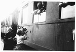 Jewish DPs say goodbye to friends from the window of a train that will take them to the harbor where they will board the Marine Perch to America.