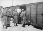 German soldiers oversee the boarding of Jews from the Zyradow ghetto onto a deportation train.