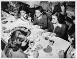 Jewish DP girls sit around a table eating ice cream at a party in the Schlachtensee displaced persons camp.