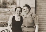 Two young Jewish women pose with their arms around each other in front of a house.