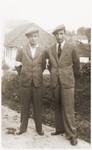 Two Jewish brothers wearing armbands pose outside in the Wisnicz Nowy ghetto.