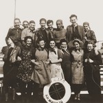 Group portrait of members of the Hashomer Hatzair Zionist youth aboard one of the riverboats (the Kraljica Marija) of the Kladovo transport.