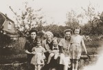 Austrian Jewish refugee Kathe Spiegler (second from the right) poses with the British family who hired her to be a nanny.