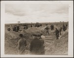 German civilians dig graves for concentration camp prisoners killed by the SS in a barn just outside Gardelegen.