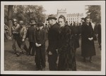 German civilians from Ludwigslust pause for a moment of silence at the mass funeral on the palace grounds of the Archduke of Mecklenburg, where they have been forced by U.S.