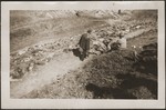 A German civilian from Nammering looks at the corpses of prisoners exhumed from a mass grave near the town.