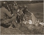 German civilians are forced to see the bodies of prisoners exhumed from a mass grave near Nammering.