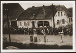 German civilians from Gardelegen march to a barn just outside the town, where they will dig graves for prisoners killed by the SS inside the barn.