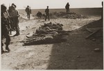 Under the supervision of American soldiers, German civilians exhume a mass grave containing the bodies of concentration camp prisoners killed by the SS in a barn outside Gardelegen.