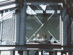 Two students look out from the third floor glass bridge in the permanent exhibition at the U.S.
