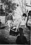 Two children carry water to the Chateau de la Hille.
