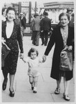 Lea Abramowicz and her sister-in-law Golda Orbach go for a walk with Lea's son, Georges, shortly after liberation.